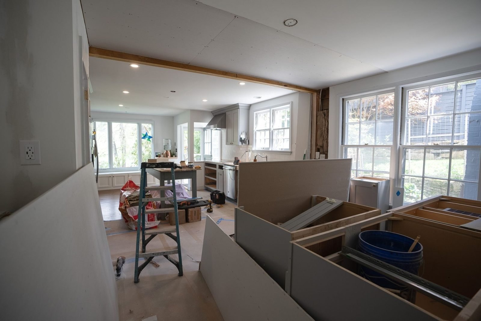 Open kitchen before: cabinet boxes being installed in a room under construction