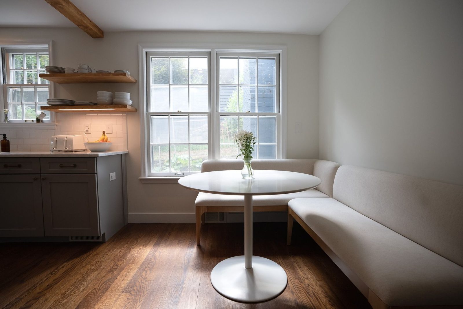 Breakfast nook with built-in bench seating and a round table