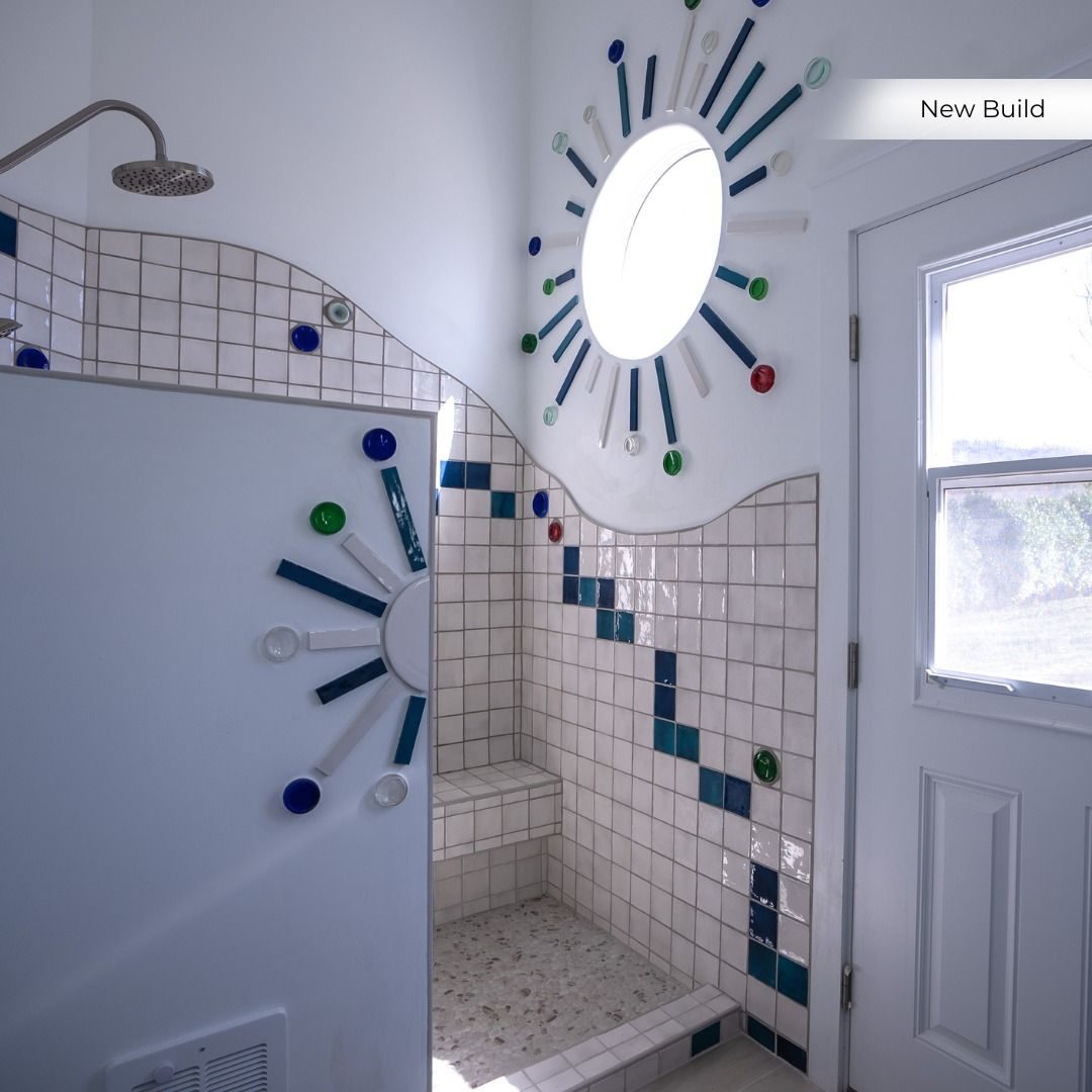 Tiled walk-in shower with a playful mosaic pattern in a new build
