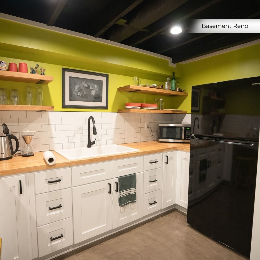 Basement kitchenette with a lime accent wall, open shelves and wood counters