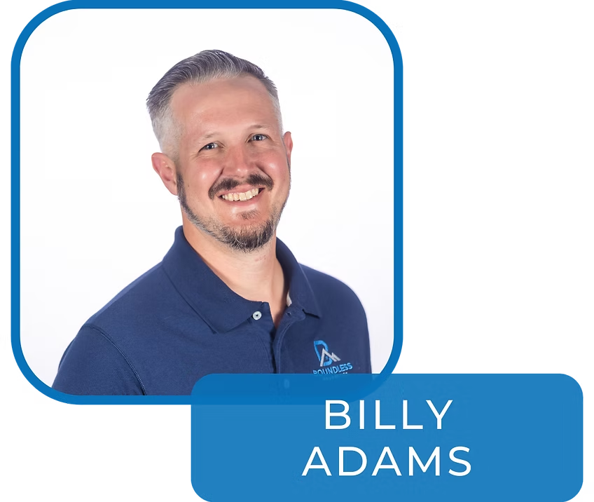 Billy Adams, founder and general contractor, smiling in a navy polo shirt